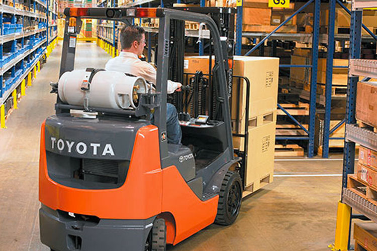 toyota cushion tire forklift turning in a warehouse aisle